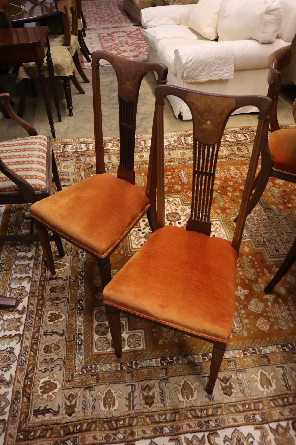 A set of four Hepplewhite style dining chairs (3 single, 1 arm) and four Edwardian dining chairs
